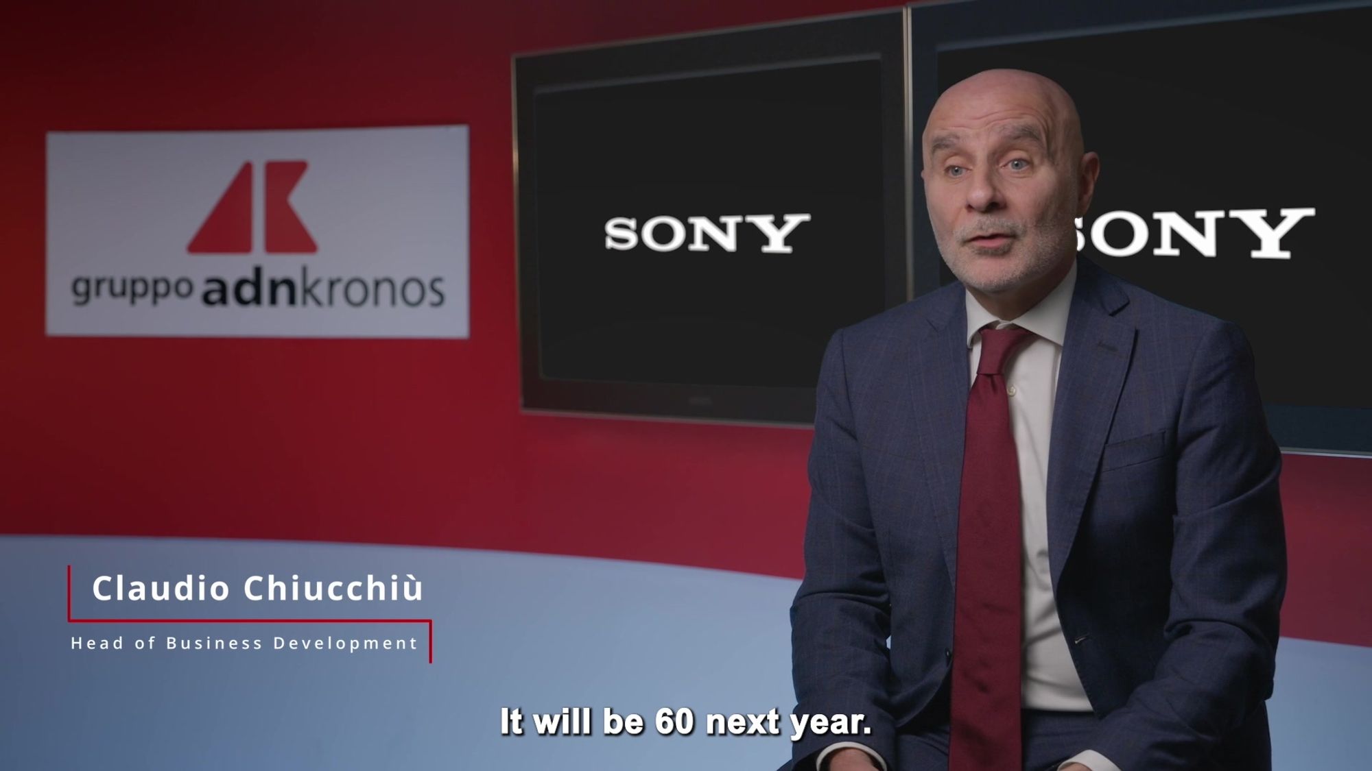 Man in an interview with grupo adnkronos and sony logos