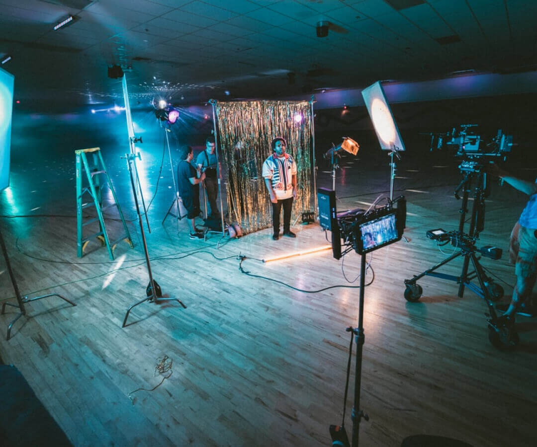 Photo set up of man with backdrops lights and cameras