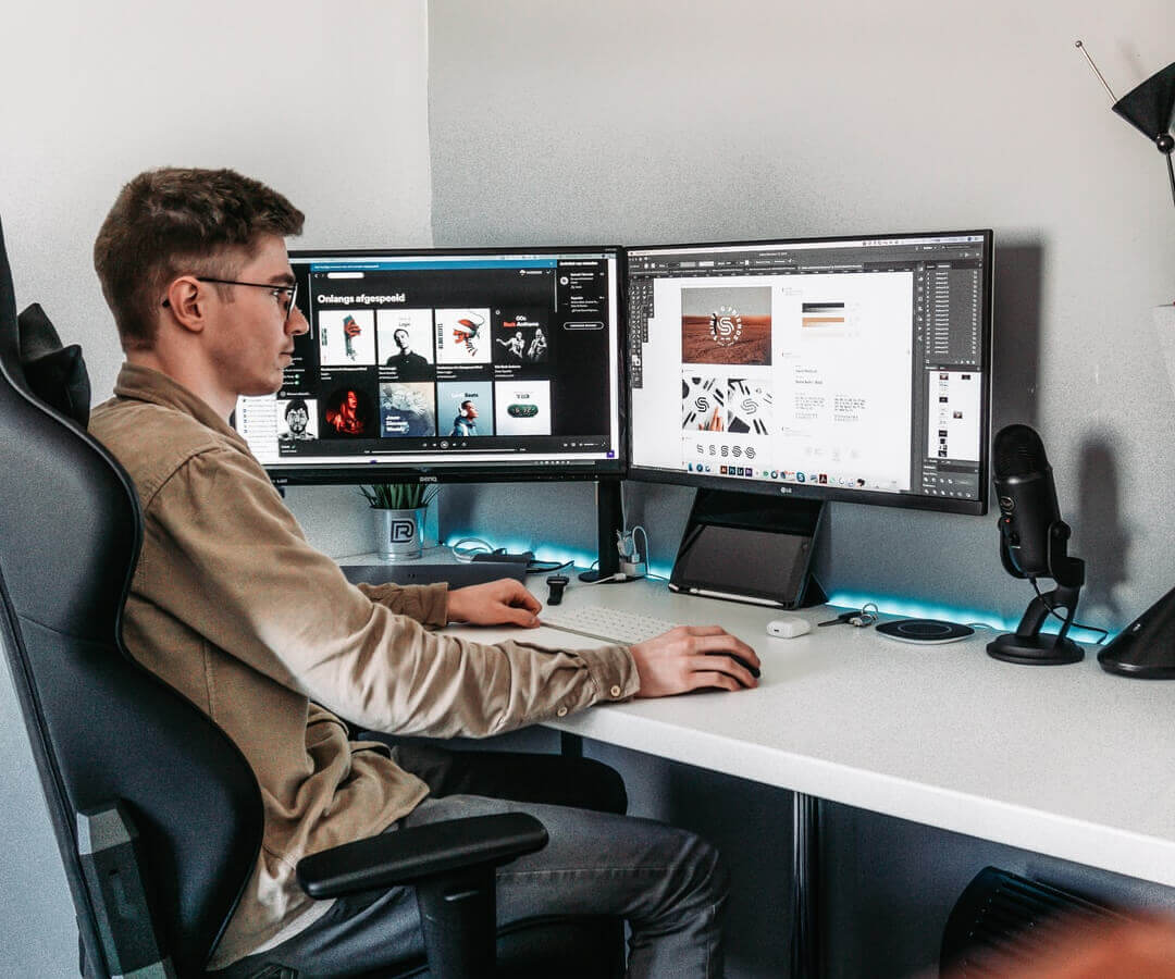 Man at a workstation looking at photo assets